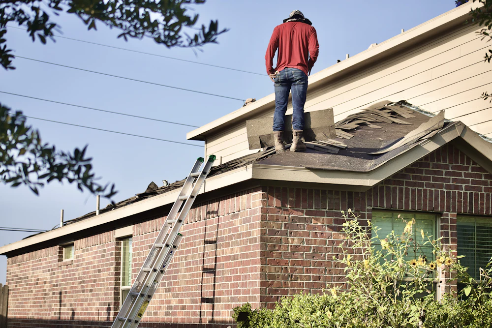 Roofer inspecting a house roof